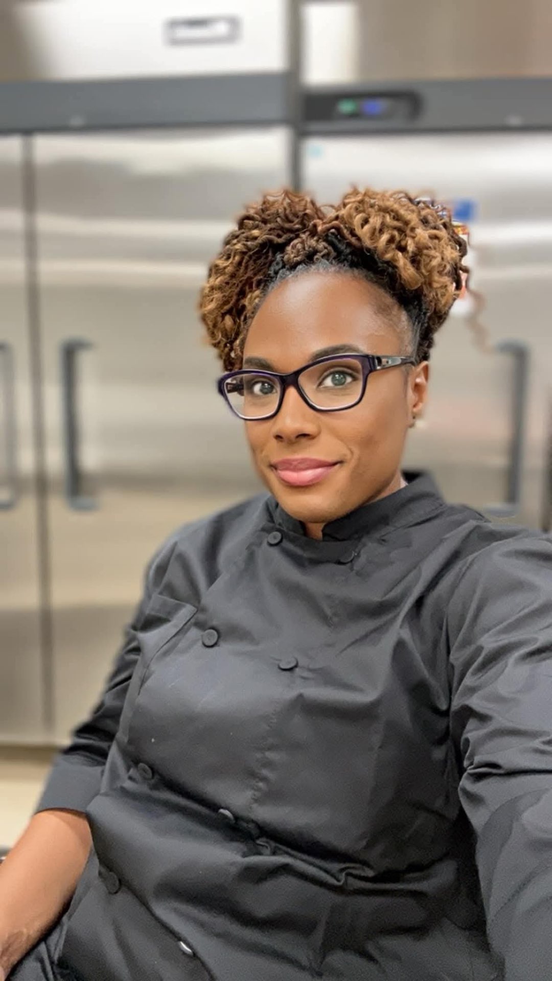 Cortnee Williams, owner and chef of Coco's Creations, holding fresh yellow bell peppers